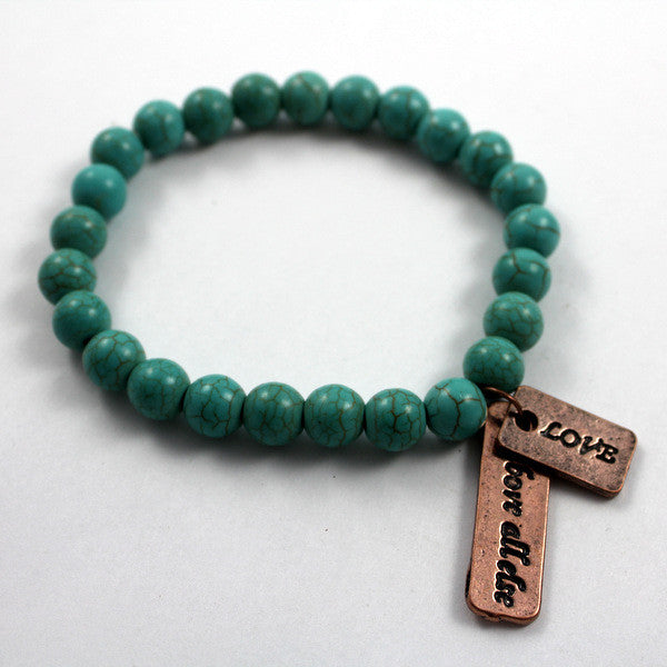 Turquoise beaded bracelet with Copper toned Love Above All Else Charm
